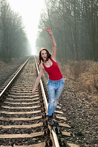 istock Young girl balancing on rails. 485473321