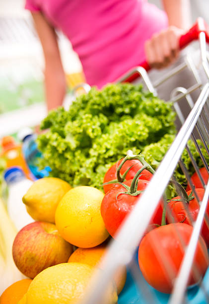 istock Shopping cart filled with vegetables and fruit 485473406