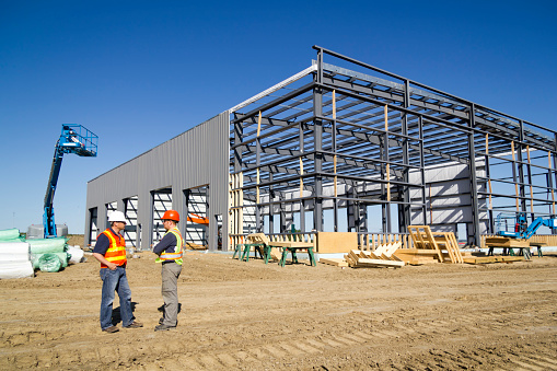 A royalty free image from the construction industry of two architects at a steel frame building site.