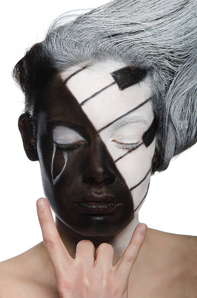 young  woman with face art and rock gesture