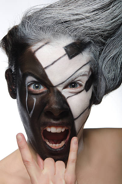 istock Portrait with musical makeup and rock gesture 485474027