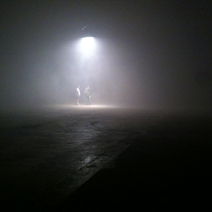Foggy Street Scene With People Under Lantern
