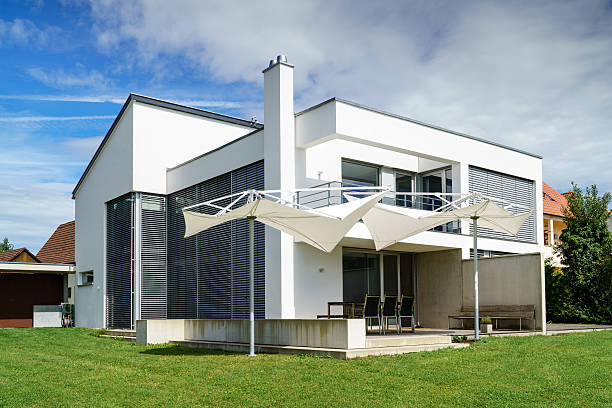 KIYV, UKRAINE - AUGUST, 23, 2017: Close up on Modern House with  Blinds Sun Protection with Glass Balcony. Windows in New Modern Passive House Attic with Shutters Closed and Opened Outdoors.