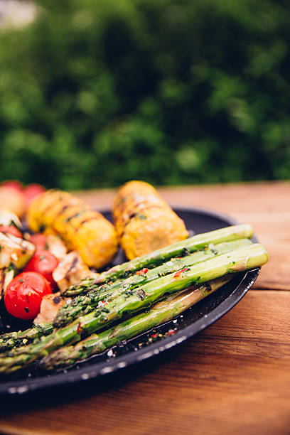 istock Healthy grilled vegetables on a plate outdoors on wooden table 485478480