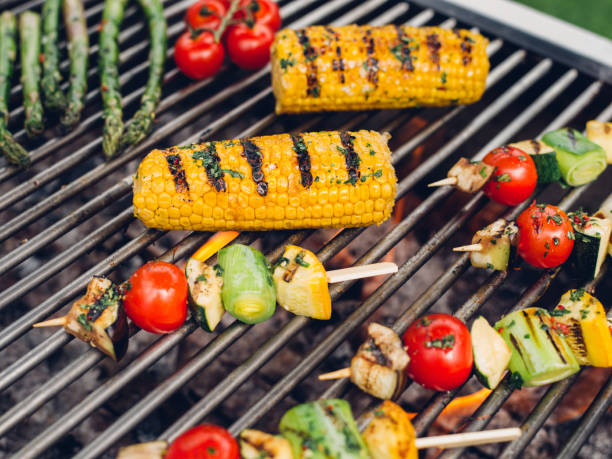 istock Vegetable kebabs, corn, asparagus, vine tomatoes grilling on a barbecue 485478484