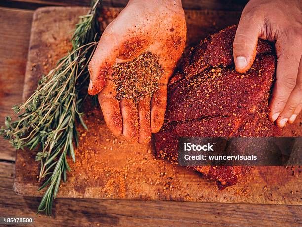 Hand Showing Spicy Seasoning With A Piece Of Raw Pork Stock Photo - Download Image Now