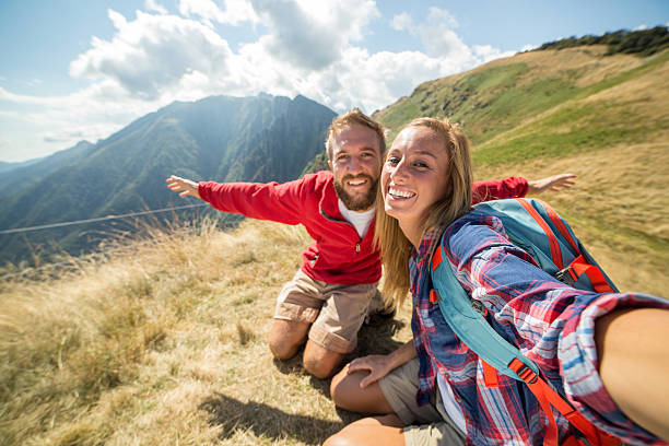 istock Young adults hiking taking selfie at mountain top 485478680