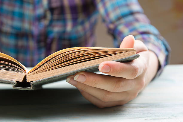 istock Closeup hand open book for reading concept background 485478762