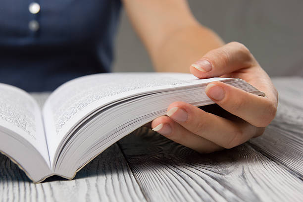 istock Closeup hand open book for reading concept background 485478764
