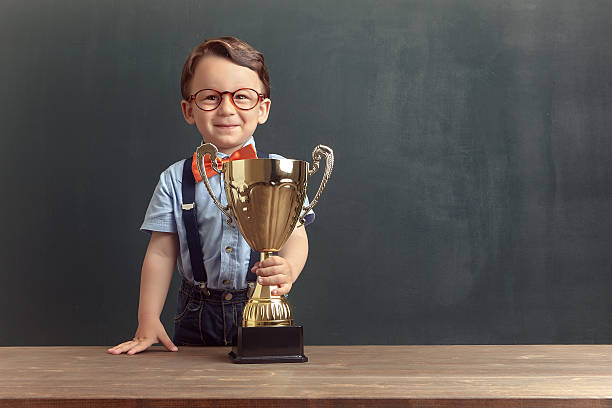 istock Little boy holding a golden trophy 485479220