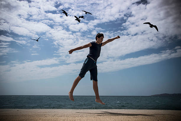 istock Young Boy Jumping in the Air 485485982