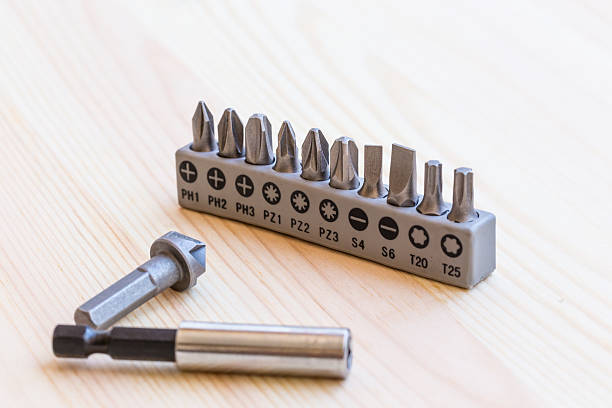 istock Screwdriver tips border on the wooden background. 485487320