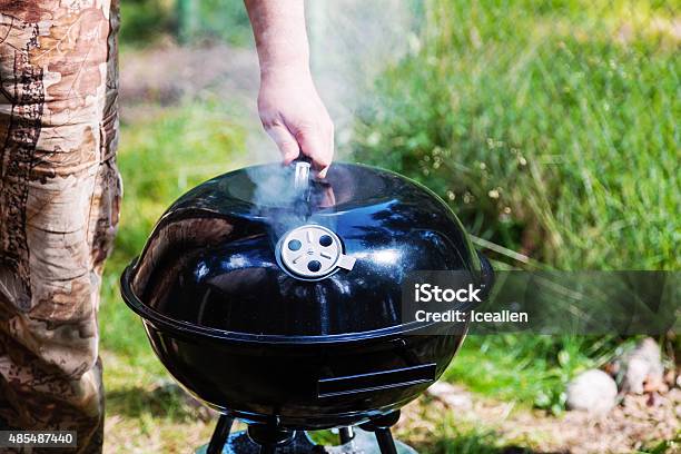 Chef Hand Holding The Lid Closed Grill Stock Photo - Download Image Now - Barbecue Grill, Barbecue - Meal, Lid