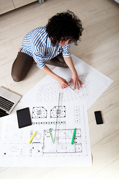istock Young female architect working at home 485487660