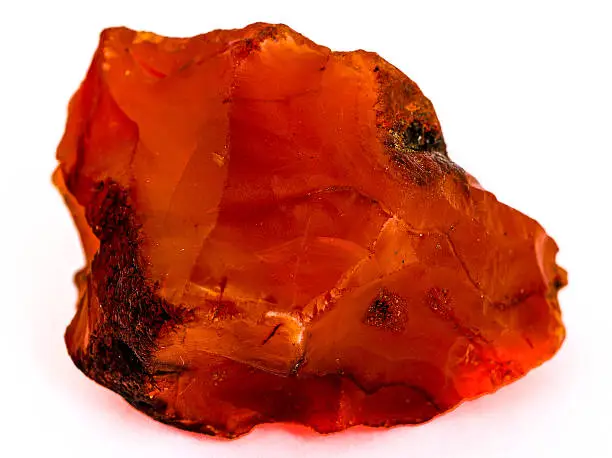 Rough red carnelian gem isolated on white background