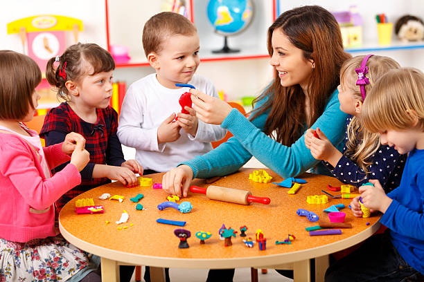 istock Nursery teacher playing with the kids 485489323