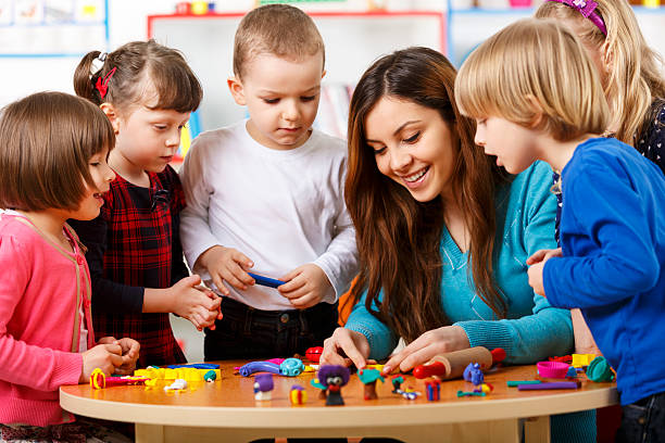 istock Nursery teacher playing with the kids 485489349