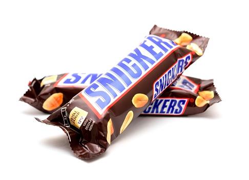 Prague, Czech Republic - April 15, 2014: Snickers chocolate candy bar on a white background