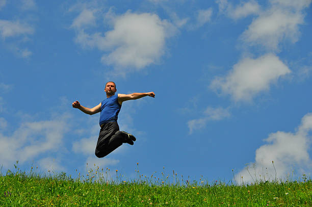 istock Beautiful man jumps high on grass 485491704