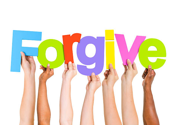 istock Multi-Ethnic Group of People Holding Letters To Form A Forgive 485492889