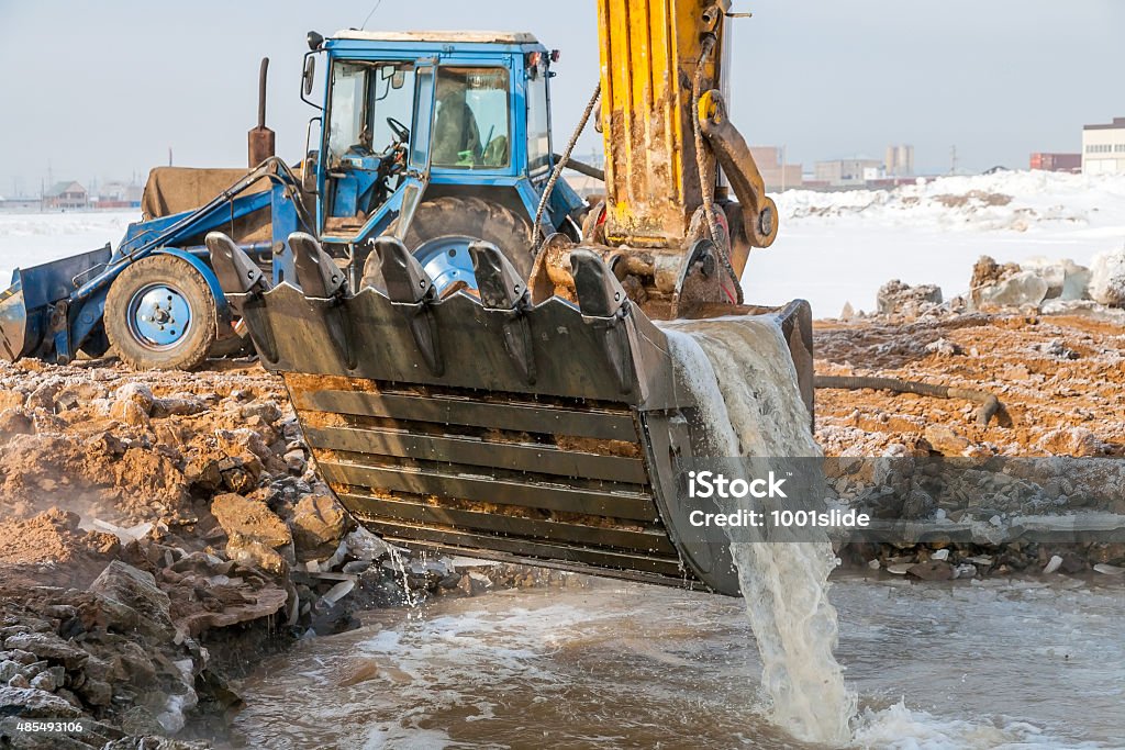 Excavator Rescue Operation Excavator in the icy water 2015 Stock Photo