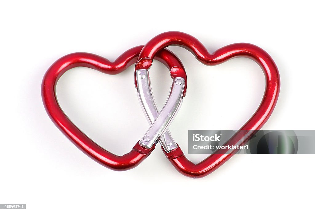 two linked heart shaped carabiner two linked heart shaped carabiner, red color Carabiner Stock Photo