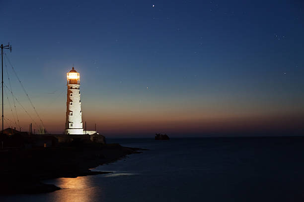 istock Lighthouse on the water edge near sea 485494687
