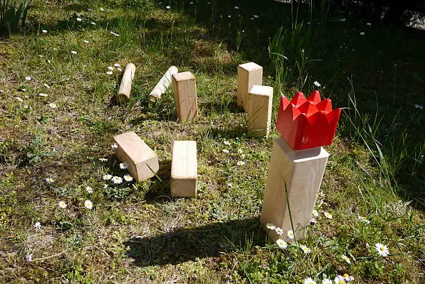 Picture of a scene from a game of kubb, also know as viking chess. Originating in Sweden