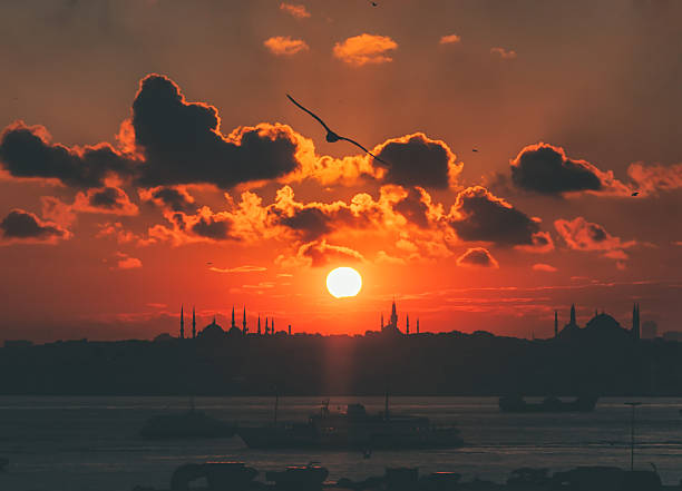 silhouette of blue mosque and hagia sophia in historical area of istanbul and bosphorus with dramatical cloudy sunset