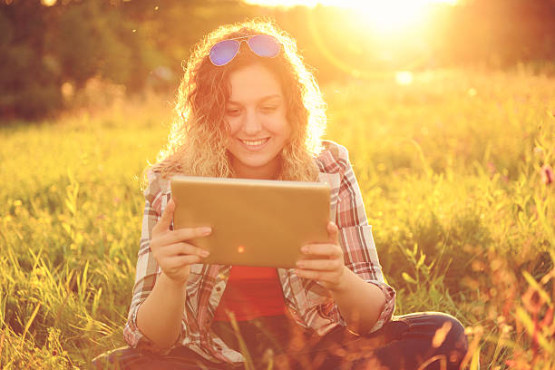 istock beautiful young woman outdoors with tablet PC 485495176