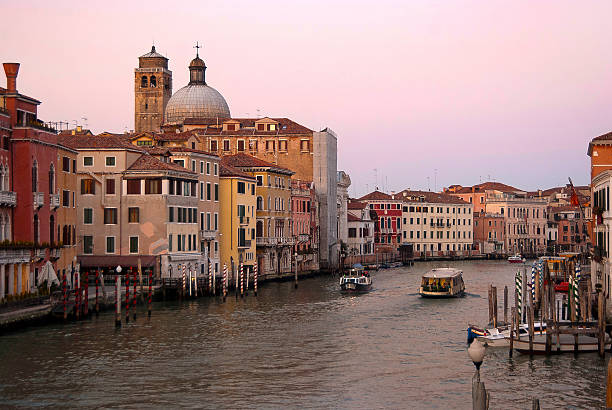 Grand Canal in Venice during sunset. Location near the railway station. A vaporetto (public transport) is on the canal.