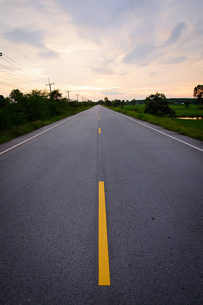 istock road leading towards the sunset 485499592