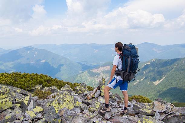 istock Man standing on slab stones and looking at Mountain Peaks 485500210