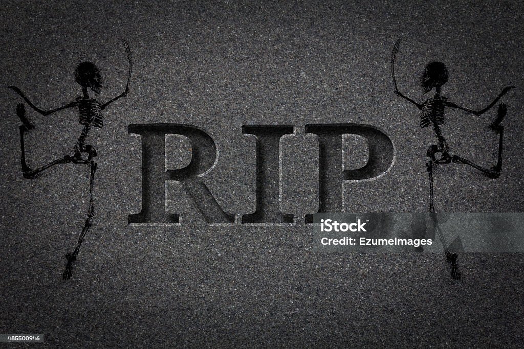 Engraved Gravestone RIP Skeleton Engraved headstone spelling the letters RIP with Skeletons - rest in peace 2015 Stock Photo