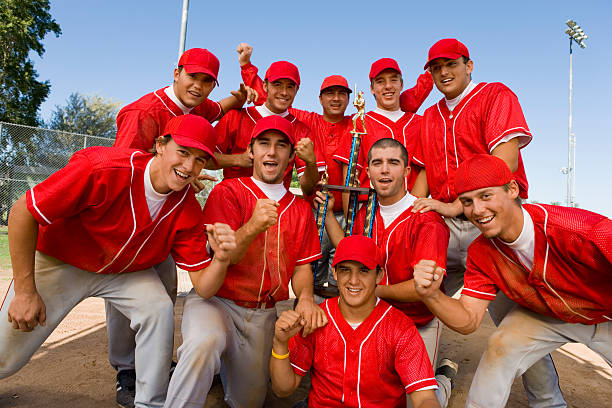 Teammates Holding Trophy Teammates Holding Trophy baseball player photos stock pictures, royalty-free photos & images