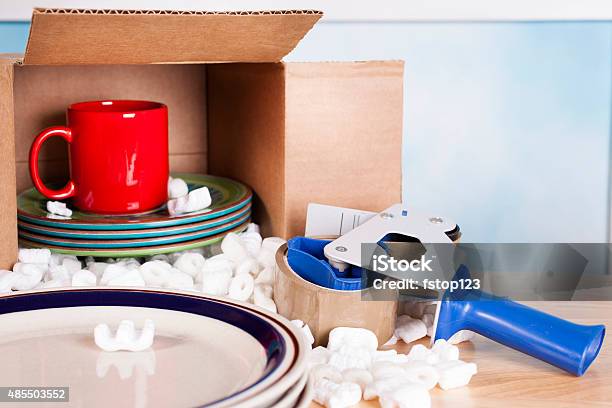 Moving Dishes Cups Packed Inside Cardboard Box Packing Tape Peanuts Stock Photo - Download Image Now