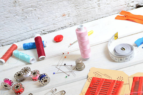 istock sewing tools and colored tape. Scissors, bobbins with thread and needles 485503722