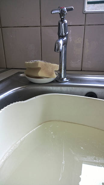 Kitchen sink with tap and bowl filled with water