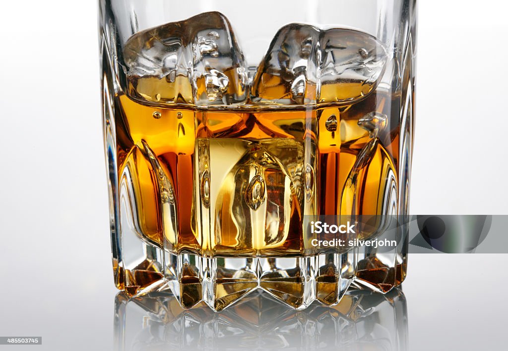 Glass of whiskey and ice over dark background Cocktail Stock Photo