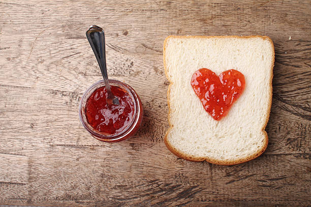 istock slice of bread with strawberry jam in heart shape 485504110