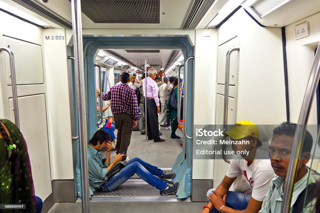 passengers in metro station with arriving train in Delhi Delhi, India - November 10, 2011: passengers in the new modern train in Delhi. India. Nearly 1 million passengers use the metro daily. Arrival Stock Photo