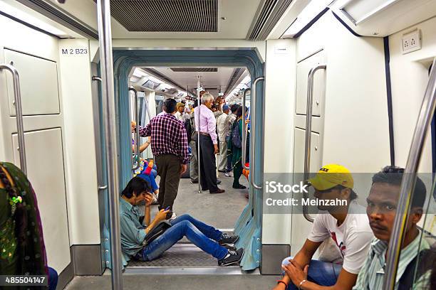 Passengers In Metro Station With Arriving Train In Delhi Stock Photo - Download Image Now