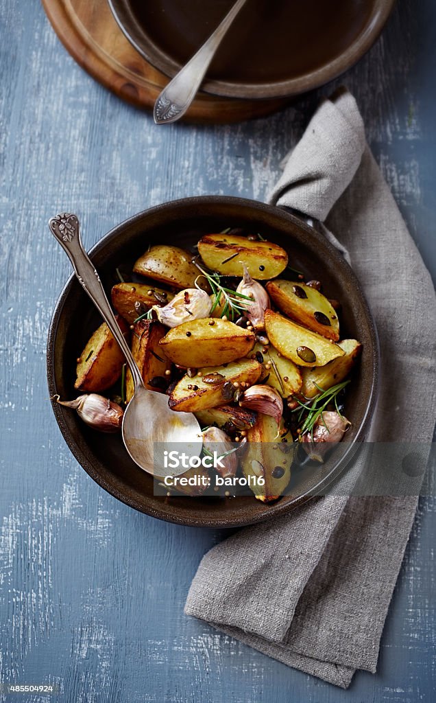 Oven-baked potatoes with pumpkin seeds, garlic and herbs (autumn style) Oven-baked potatoes with pumpkin seeds, garlic and herbs (seen from above) Autumn Stock Photo