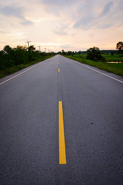 istock road leading towards the sunset 485505324