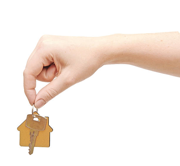 istock hand with chrome house key isolated on white 485506415