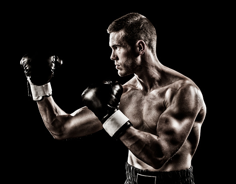 Caucasian boxer on black background