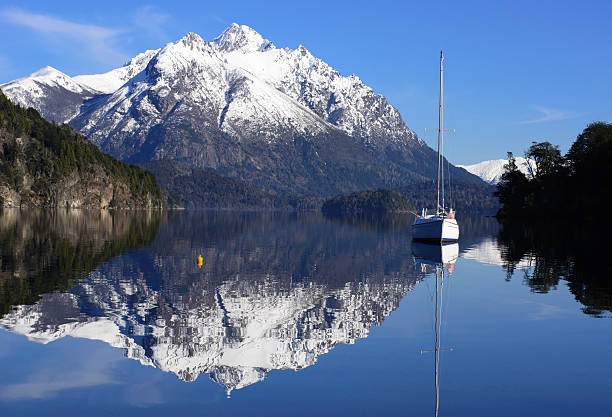 Sailing Between the Mountains of Patagonia Sailing in the Nahuel Huapi National Park, San Carlos de Bariloche, Patagonia, Argentina. nahuel huapi national park stock pictures, royalty-free photos & images