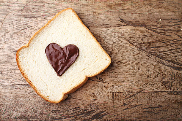 istock slice of bread with chocolate sauce in heart shape 485509904