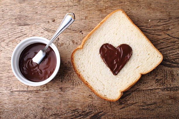 istock slice of bread with chocolate sauce in heart shape 485509924