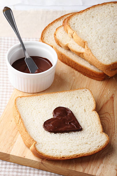 istock slice of bread with chocolate sauce in heart shape 485509964